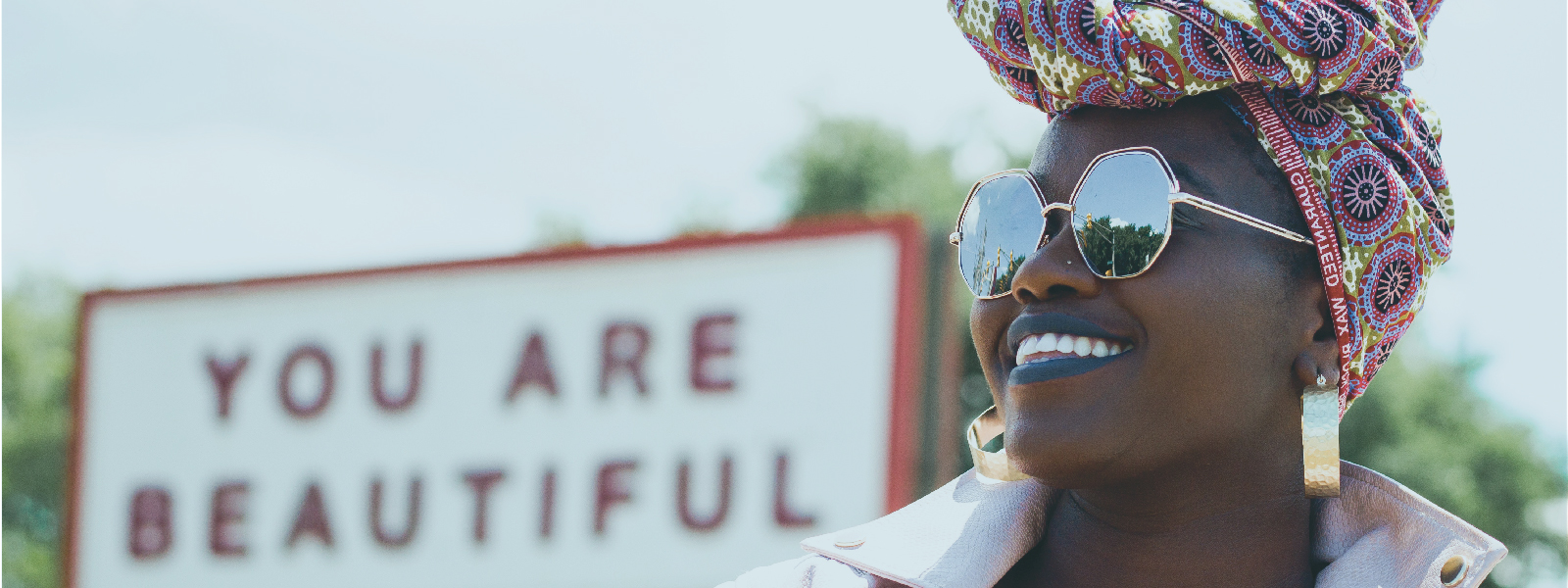 a woman wearing sunglasses and a headscarf